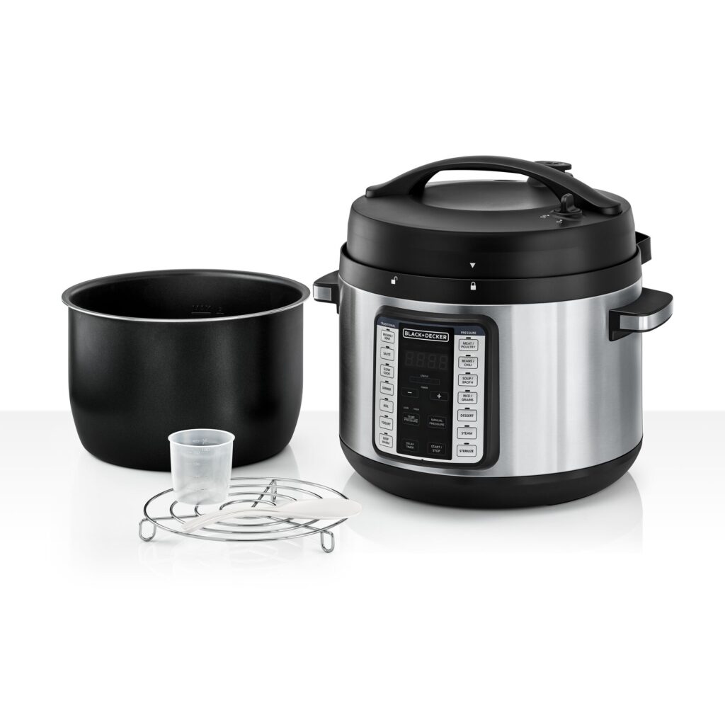 Black+Decker PCP1010 pressure cooker shown with its inner pot, steaming rack, and measuring cup