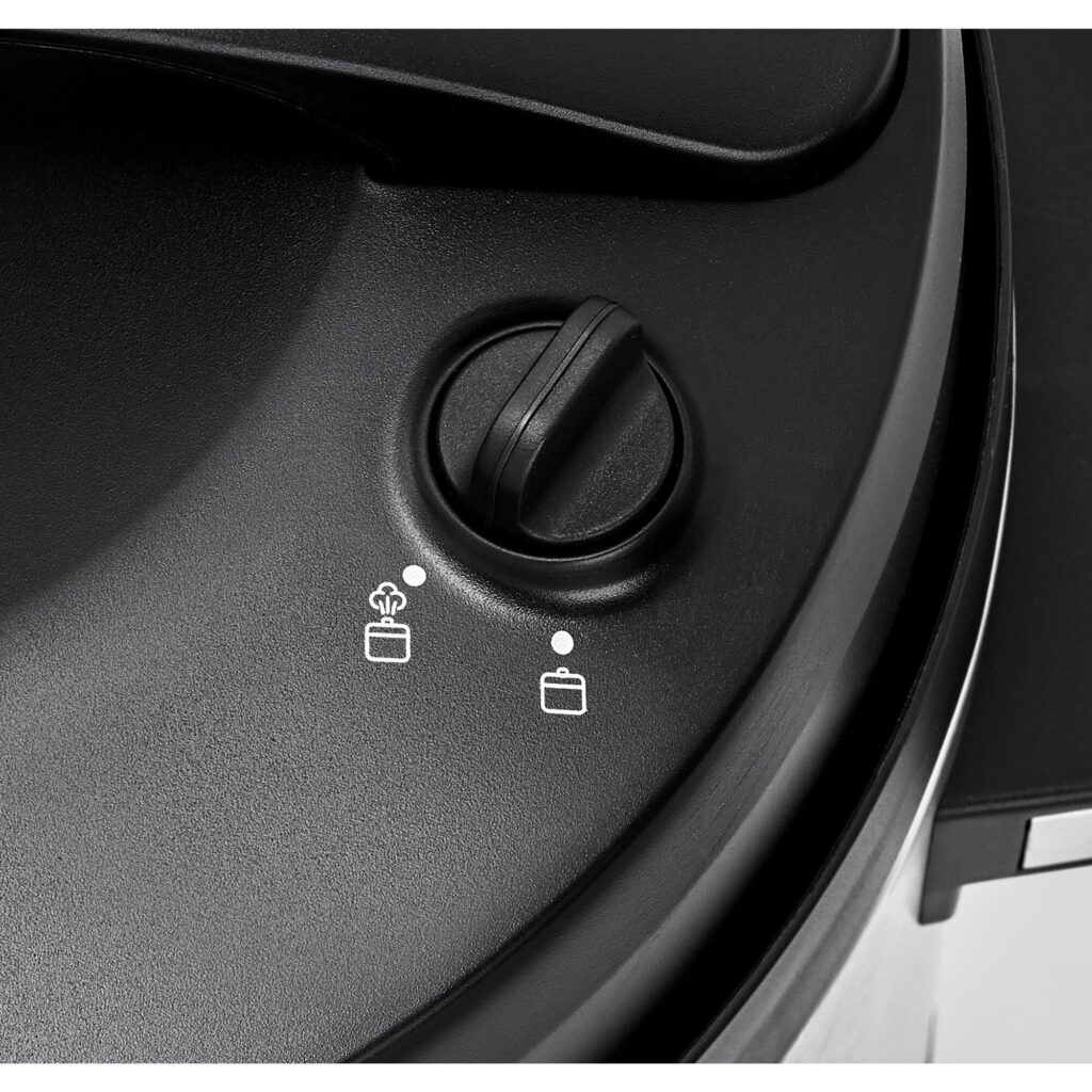 Close-up of the pressure release knob and lock icons on the Black+Decker PCP1010 lid