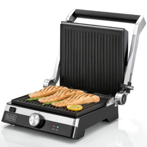 Open Black+Decker 2000W electric contact grill in black and silver, grilling salmon fillets and asparagus on non-stick ridged plates.