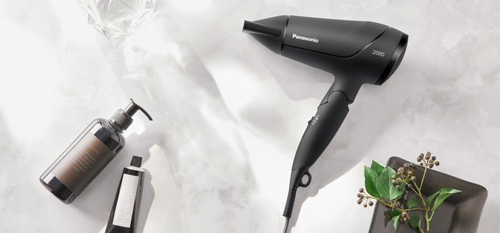 Panasonic hair dryer EH-ND65 displayed in a bathroom styling setup