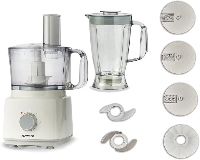 White Kenwood FDP03.C0 750W food processor unit alongside empty blender jug, dough blade, stainless steel chopper blade, emulsifying disc, and three grating and slicing disc attachments.